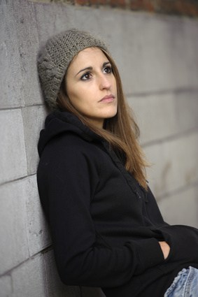 sad young woman with knitted hat