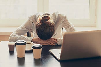 Woman sleeping on work desk