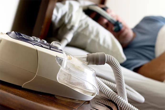 CPAP machine being used by a man during sleep