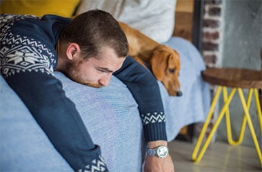 Photo of a depressed man and his dog